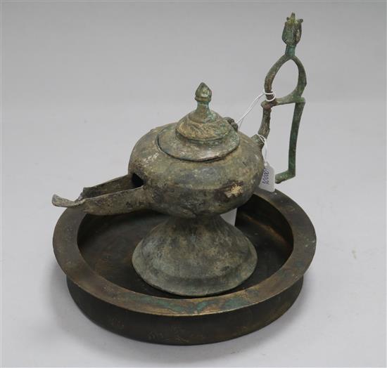An Islamic bronze incense burner and an oil lamp